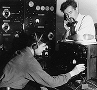 Stuart Seaton with telephone and one of the radio operators at the Ballaine Lake Receiving Station. Photo: Geophysical Institute