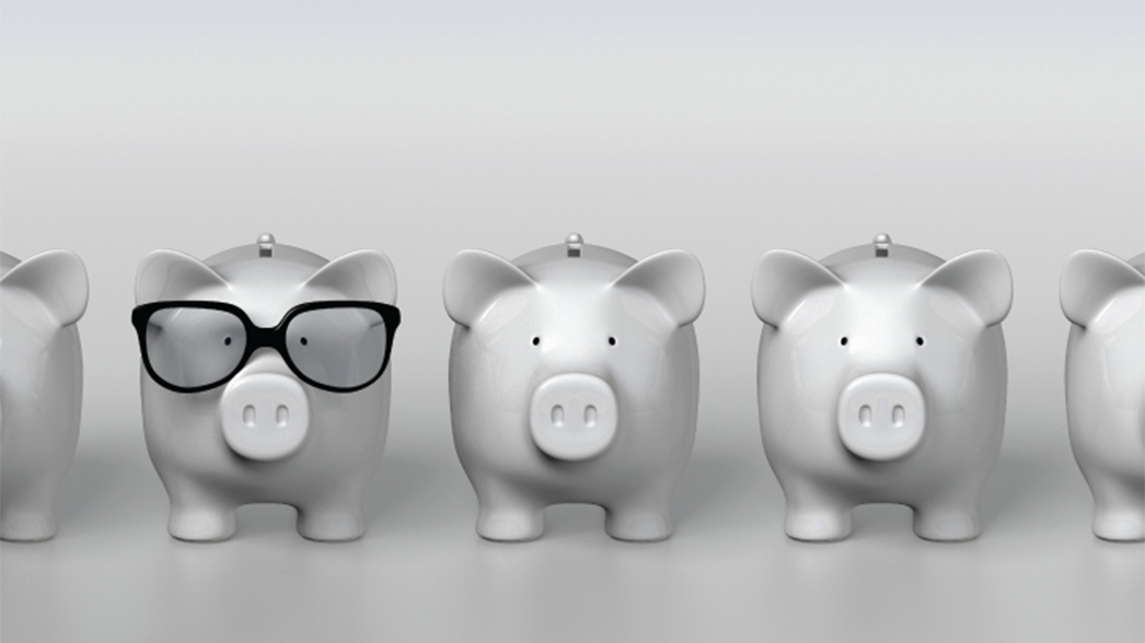 Piggy banks in a row - one wearing sunglasses