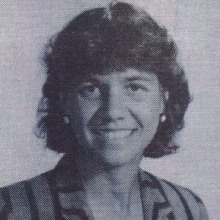archival black and white photo with a woman with short brown hair, smiling