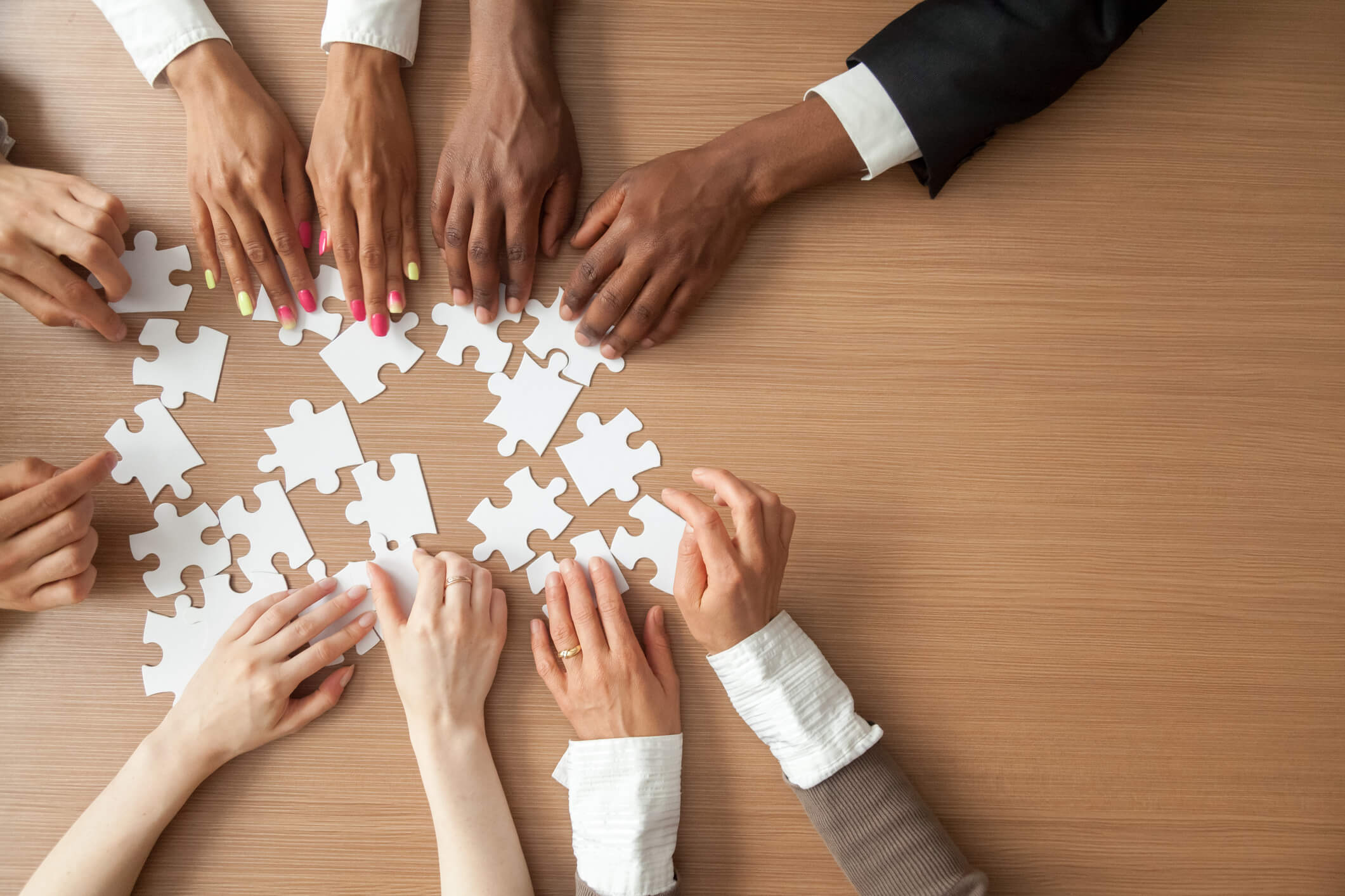 Photo of hands holding puzzle pieces