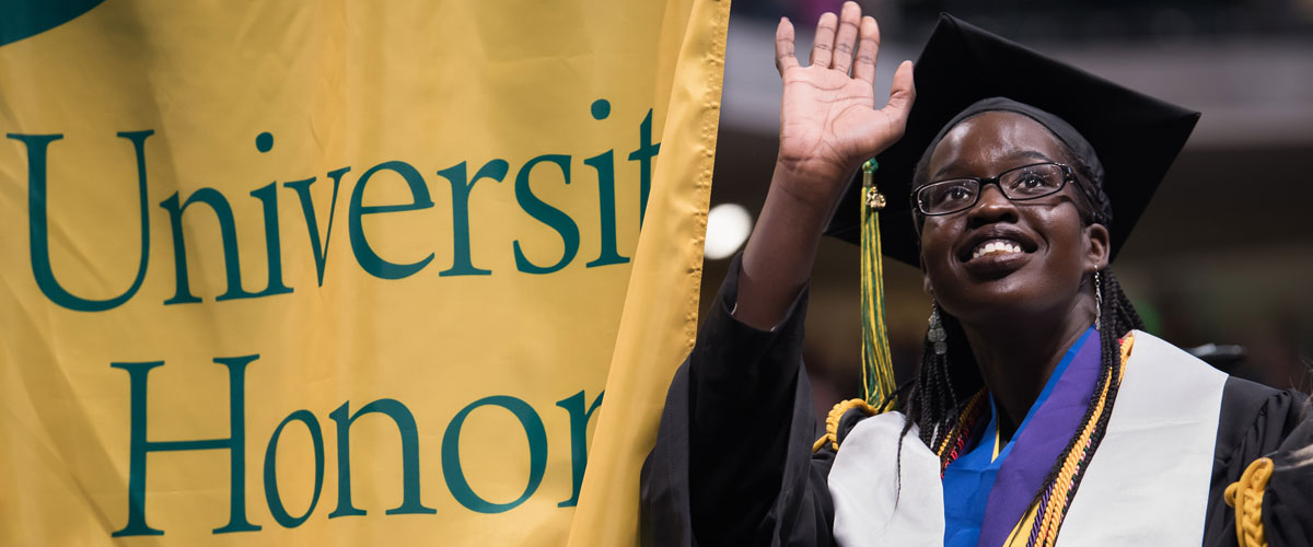 African American student at commencement wearing honor cord