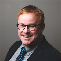 portrait of Harry need - a man with short hair smiles at the camera