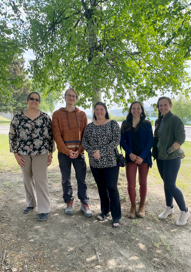 Members of the System Office Staff Council stand outdoors for a group photo