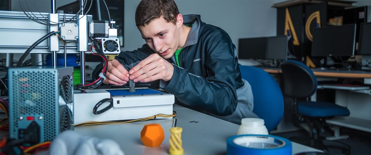 Student works with a 3-D printer