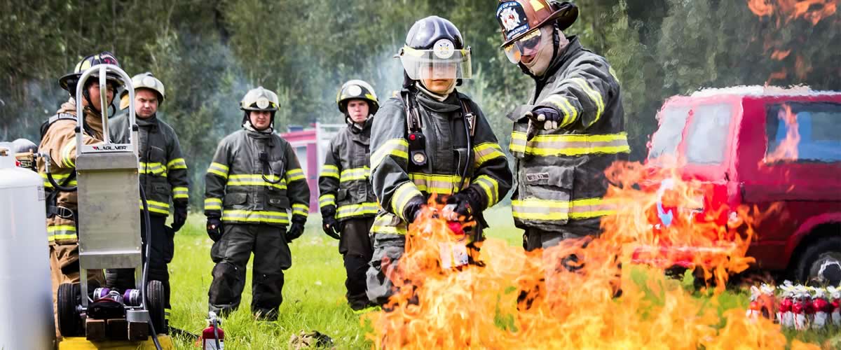 CTC fire students practice with an extinguisher