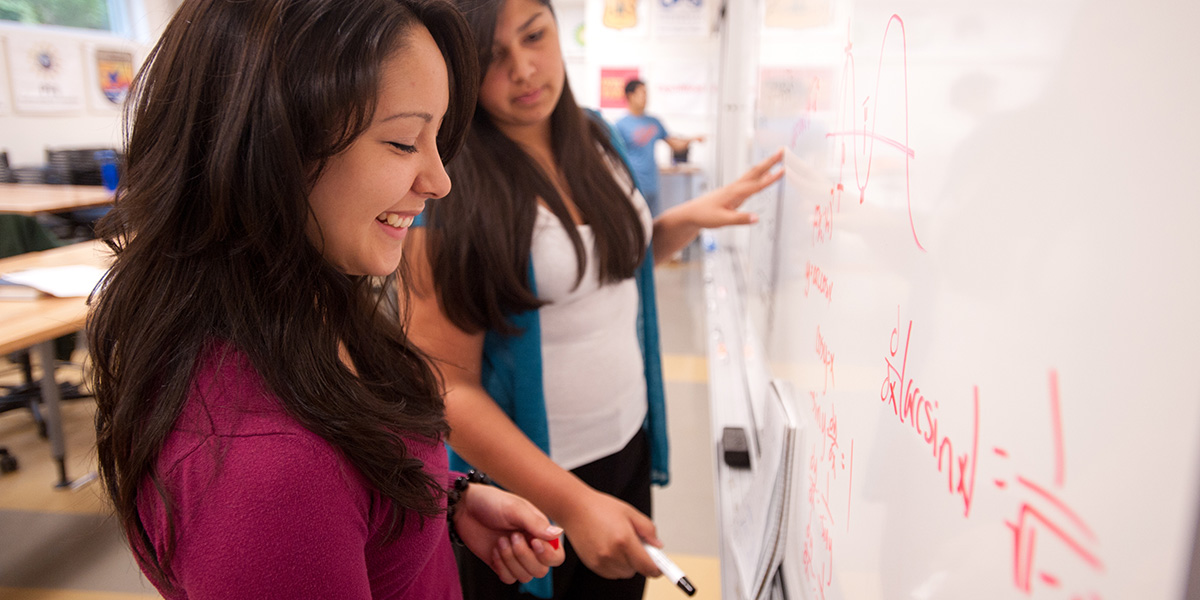 Students writing the whiteboard