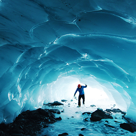 individual exploring an ice cave