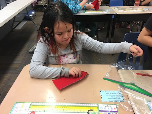 2nd grader sews mittens