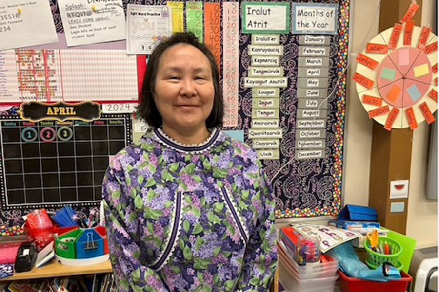 A smiling teacher in a classroom