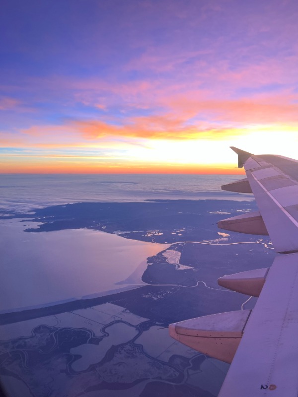 an arial view of a sunset taken from  the airplane