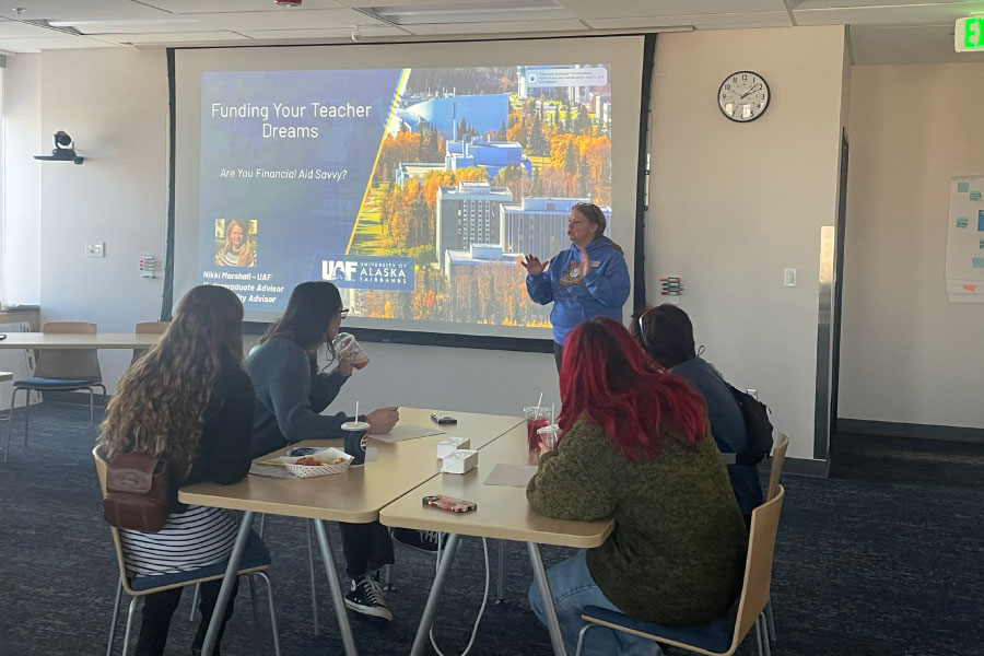 Instructor talking to a class of engaged students