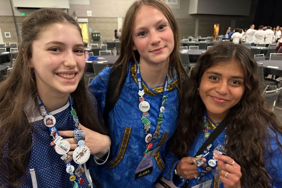 Three students smiling for the camera