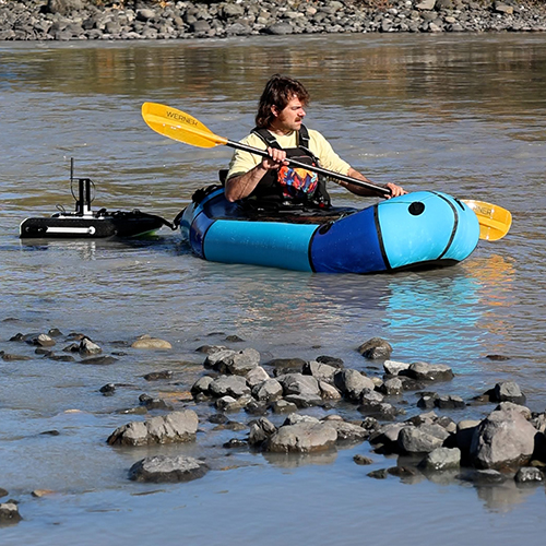 Aeon Russo performing field work in a pack raft