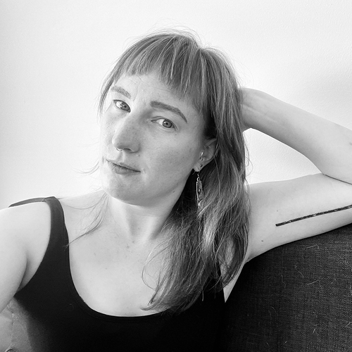Black and white headshot of Schuster on a couch