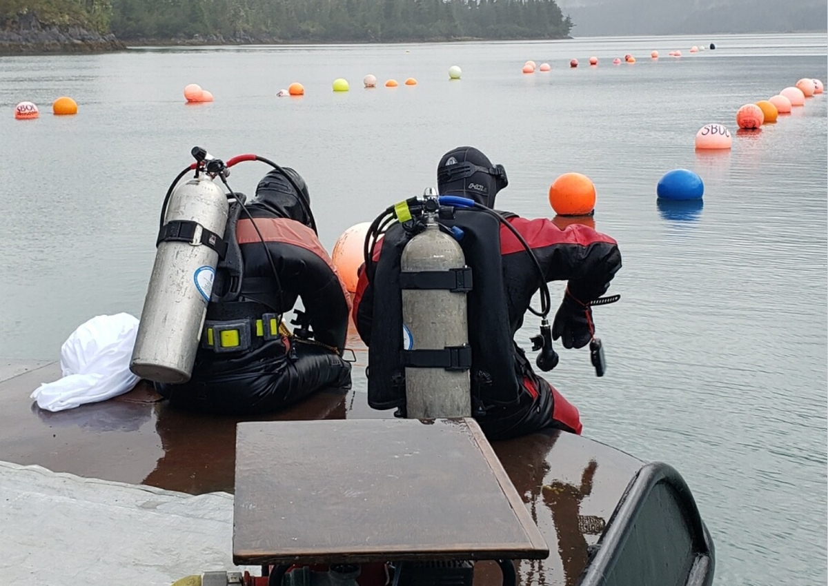 Alaska EPSCoR project director Brenda Konar, left, and postdoctoral researcher Brian Ulaski, right, prepare to survey an oyster mariculture farm in Simpson Bay near Cordova.