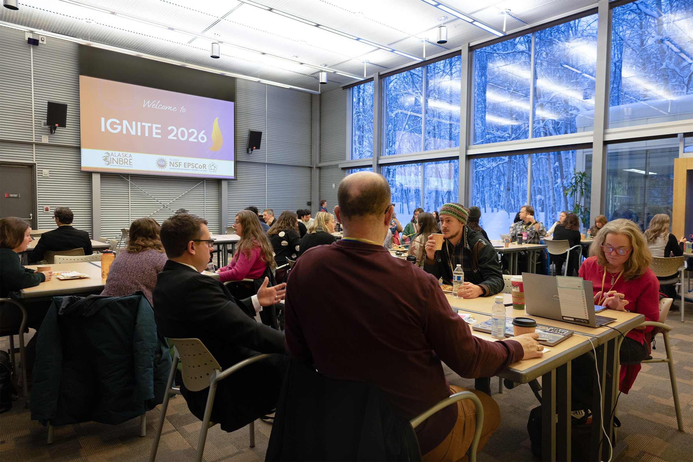 A room of people eating and getting settled at IGNITE 2026.