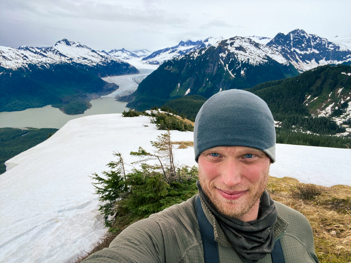 Logan Berner on the summit of Thunder Mountain, near Juneau, Alaska. The Mendenhall Glacier lies in the distance.