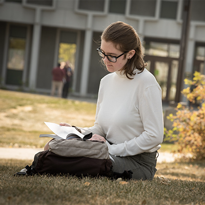 Students studies while sitting outside in the quad