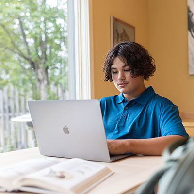Student working on a laptop doing homework