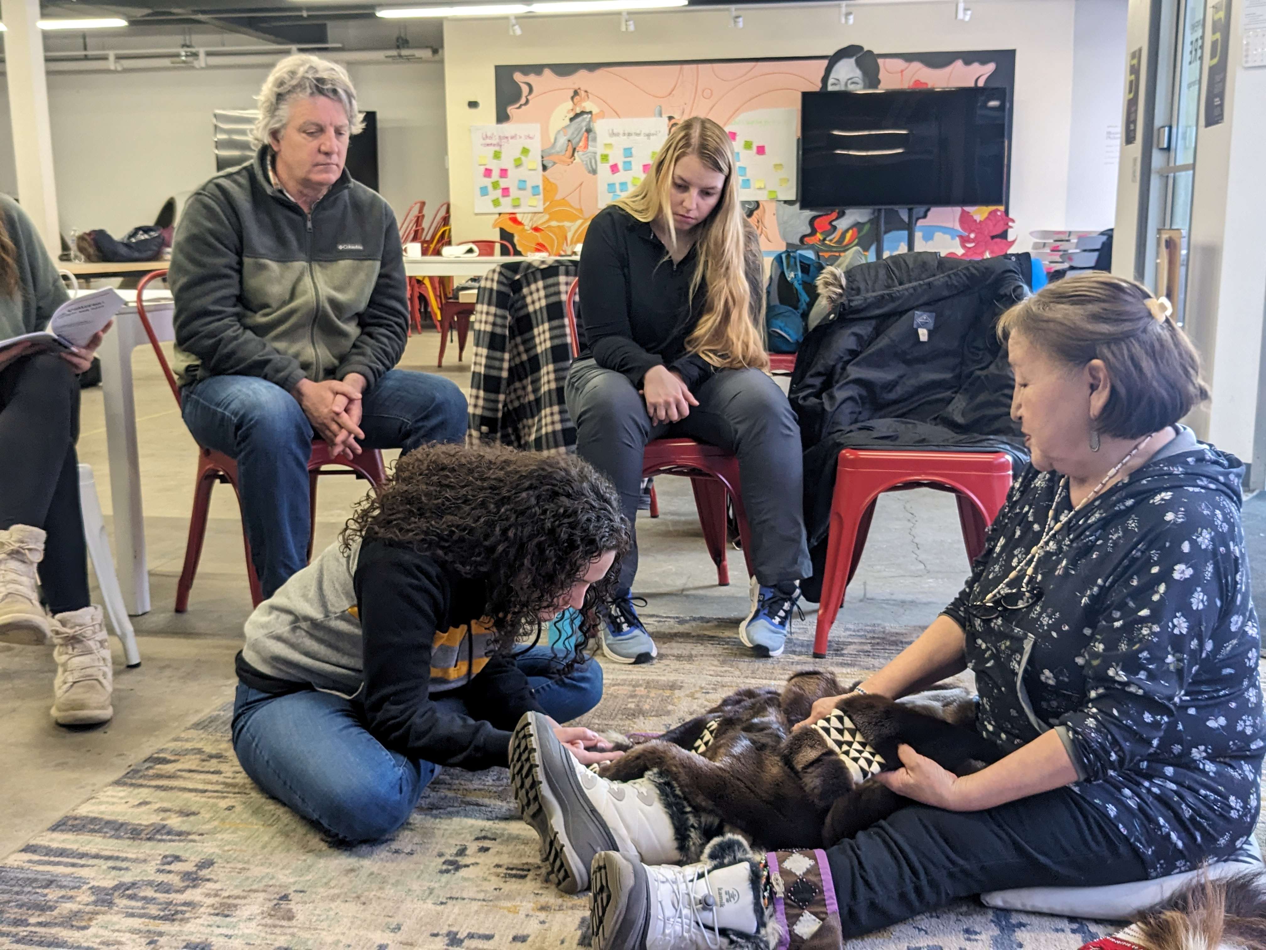 An Elder leads a traditional skin-sewing session for teachers during the 2023 summer Culture Camp in Togiak, Alaska.
