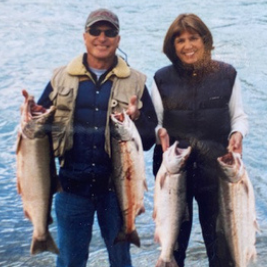 Dixie Coggins and her husband, Truman, holding salmon next to the Kasilof River