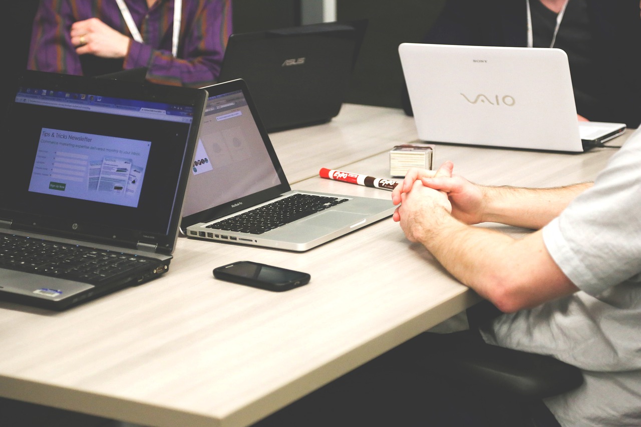 People meeting with laptops