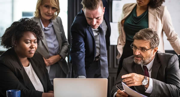 people gathered around computer