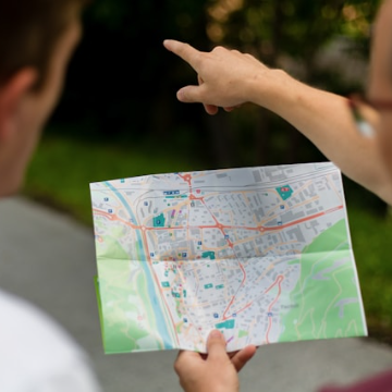 Map with hands pointing