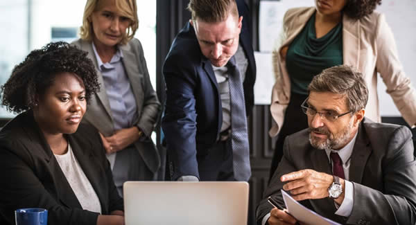 group of people in front of the laptop