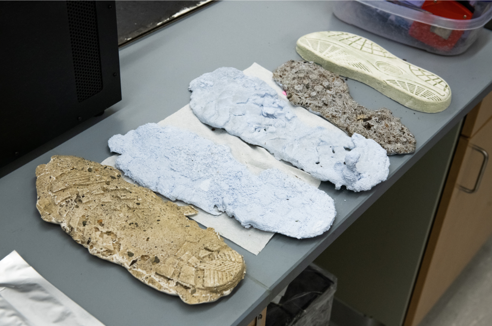  footprint analysis features 5 different molds of shoeprints on a table