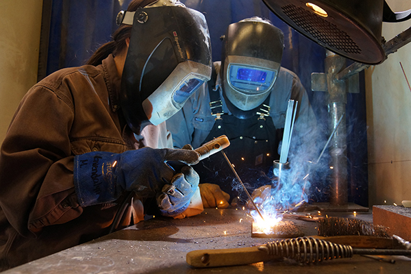 Student learning to weld