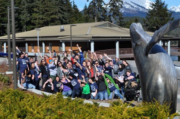 UAS students and staff pose with the humpback whale statue at UAS' main campus.