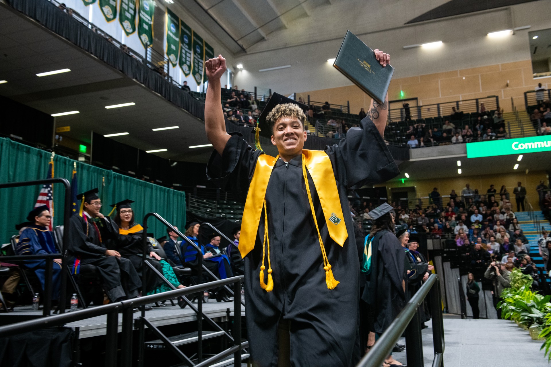 A UAA graduate celebrates after receiving his diploma during the 2023 commencement ceremony