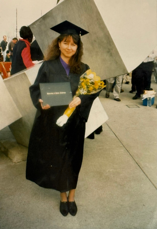 Marcy Hensch poses in cap and gown at UAA commencement in 1997, becoming the first student to graduate through the ANSEP scholarship program.