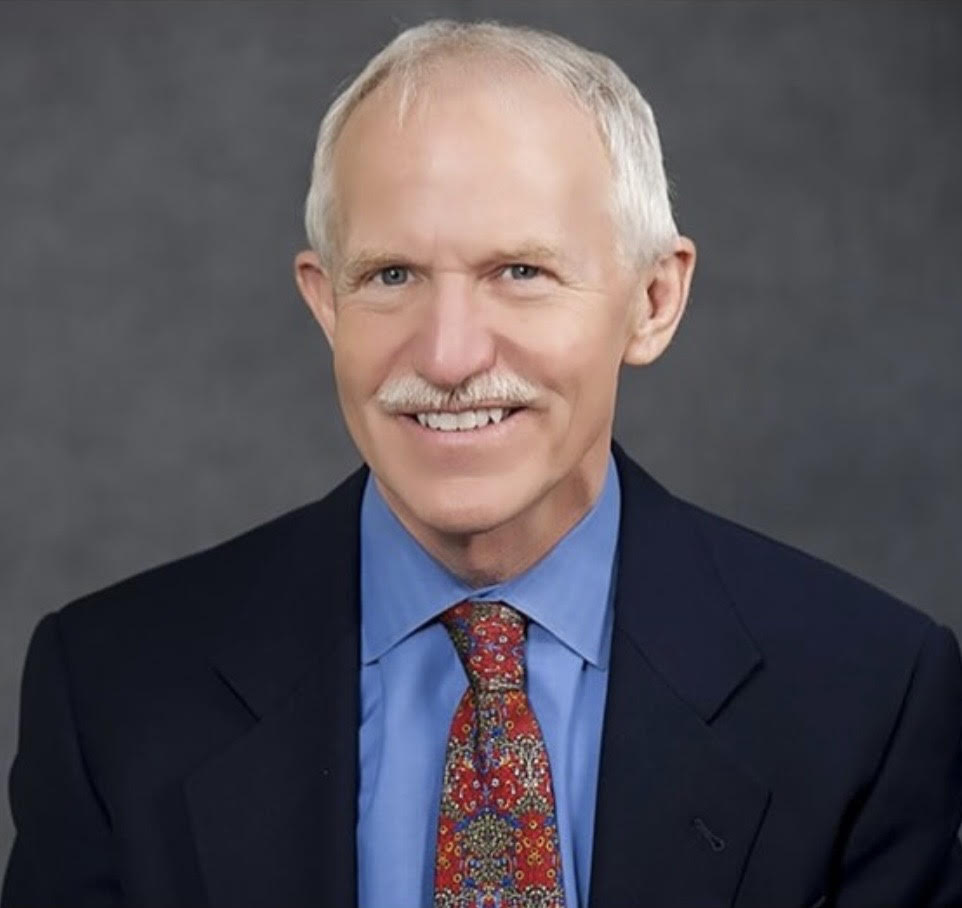 A man with grey hair and glasses