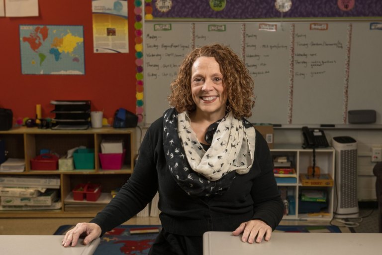 A UA faculty member poses in her classroom