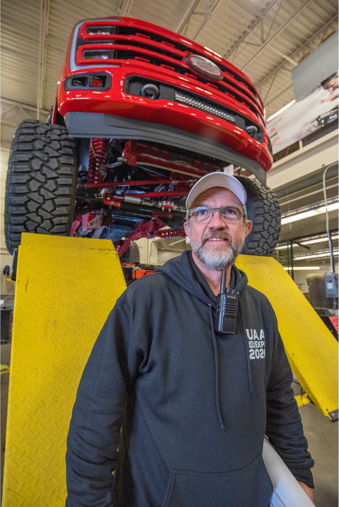 Darrin Marshall in front of a red truck