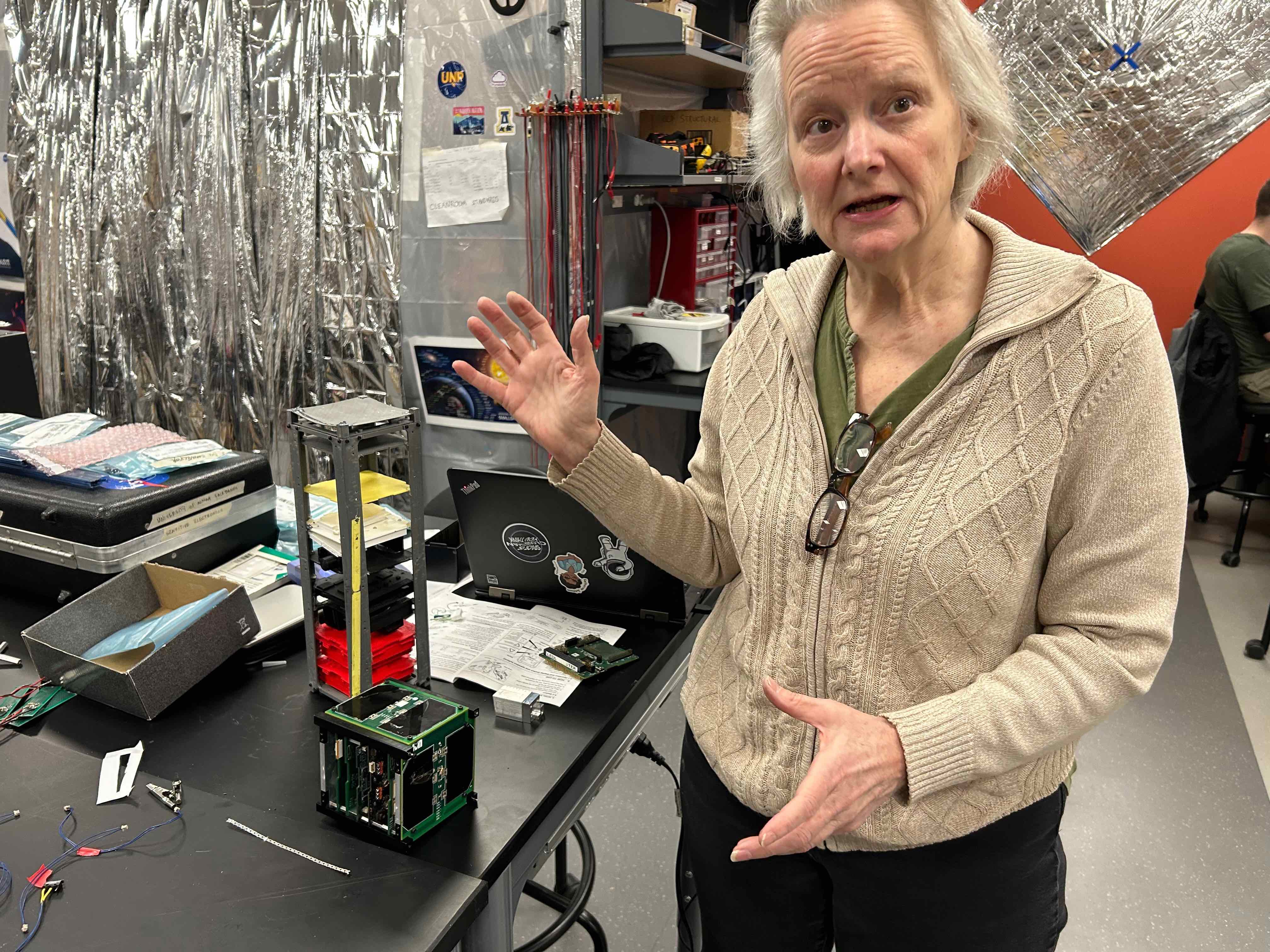 Denise Thorsen explains some of the work underway by students in the University of Alaska Fairbanks Space Systems Engineering Program earlier this year. Photo by Rod Boyce