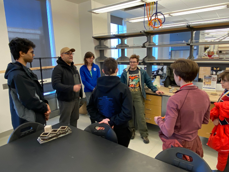 Dr. Farzadnia and ACAM graduate students Jessica McKay and Dane Woolery describing their work to the Cordova Science Olympiad students inside the lab