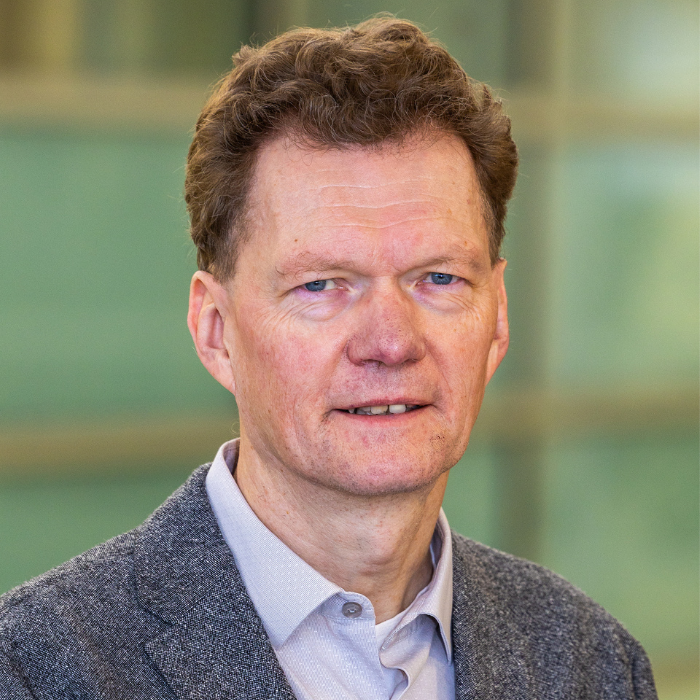 portrait of a man in grey tweed sports coat