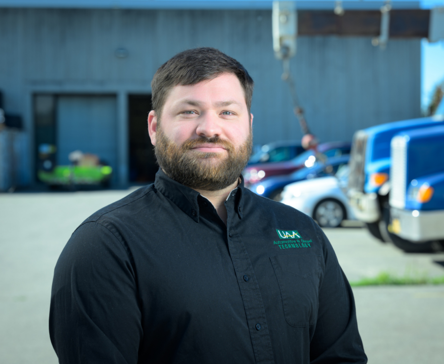 Josh Brown, diesel and EV instructor at UAA's Automotive and Diesel Technology Department, stands outside the department building in Anchorage.