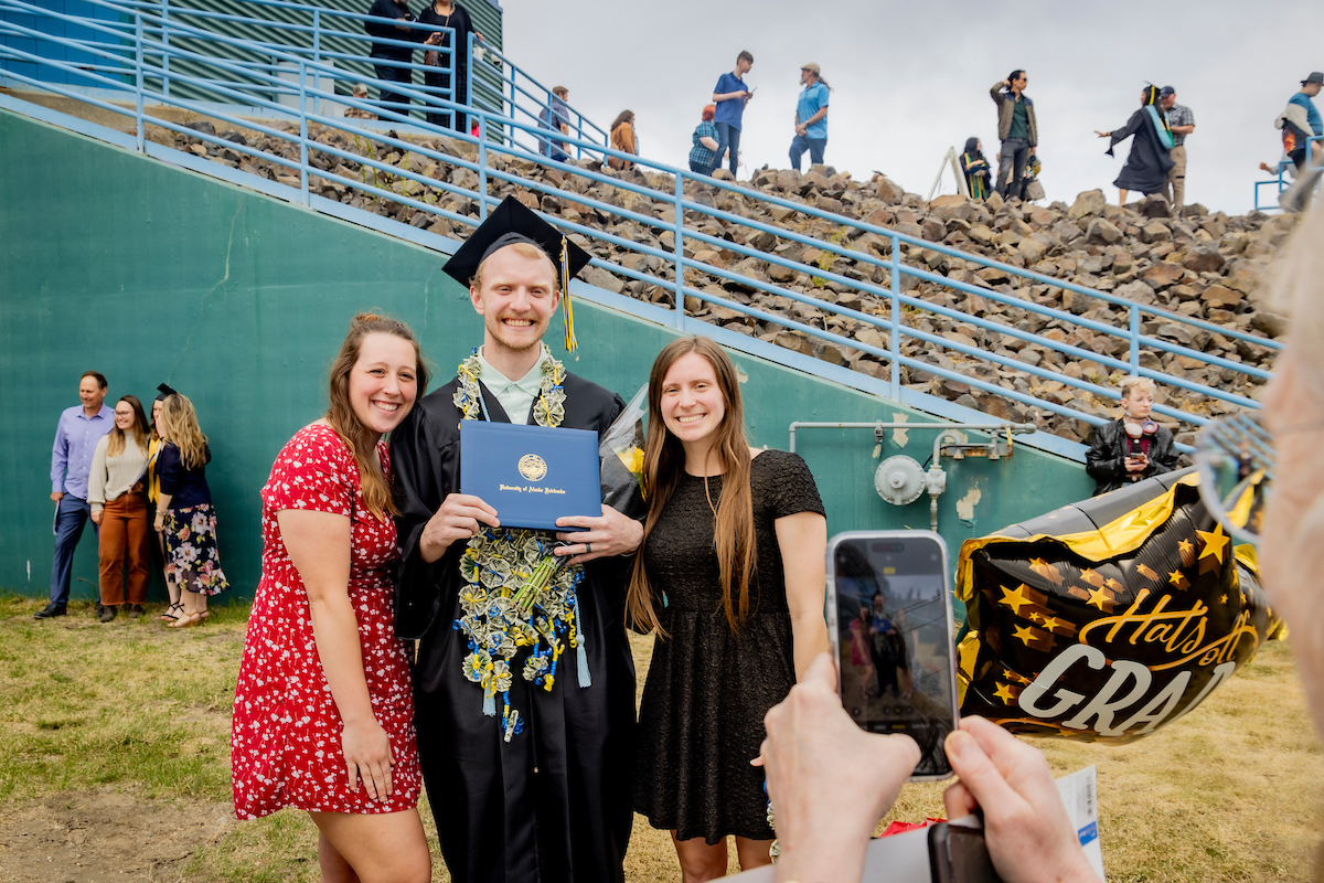 A family takes a group photo after the ceremony