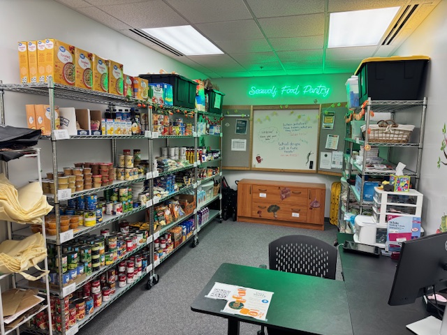 Looking inside the Seawolf food pantry, there are shelves of food and a desk