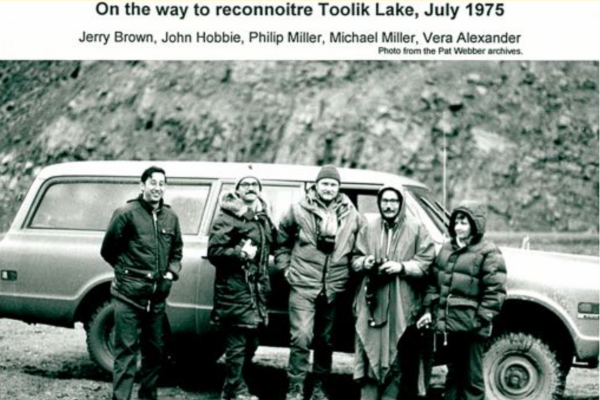 Group photo of Jerry Brown, John Hobbie, Philip Miller, Michael Miller, and Vera Alexander next to a vehicle on a dirt terrain, taken in July 1975 during a trip to Toolik Lake.