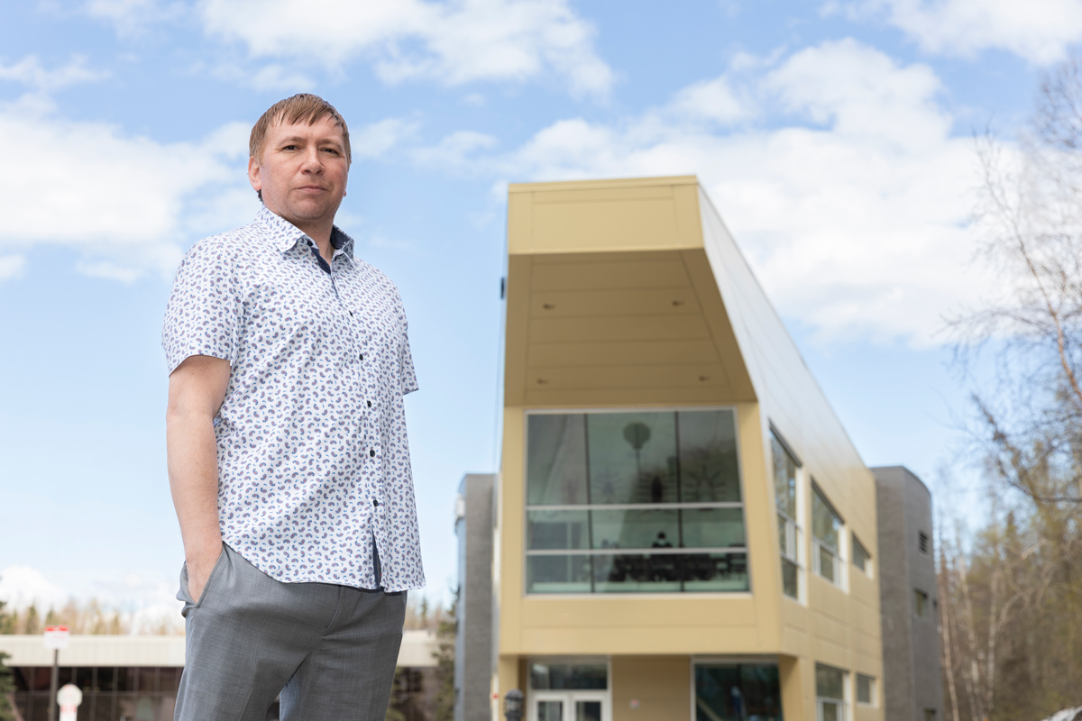 Calhoun stands in front of the ANSEP building on the UAA campus