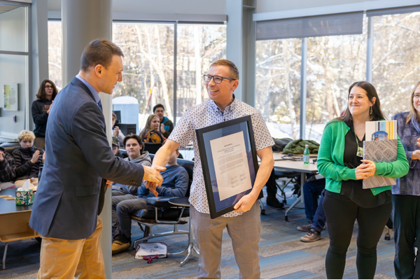 Senator Dunbar delivers a legislative citation to ANSEP leadership