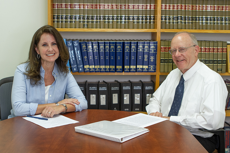 Mary Gower sits at a table with Andy Harrington