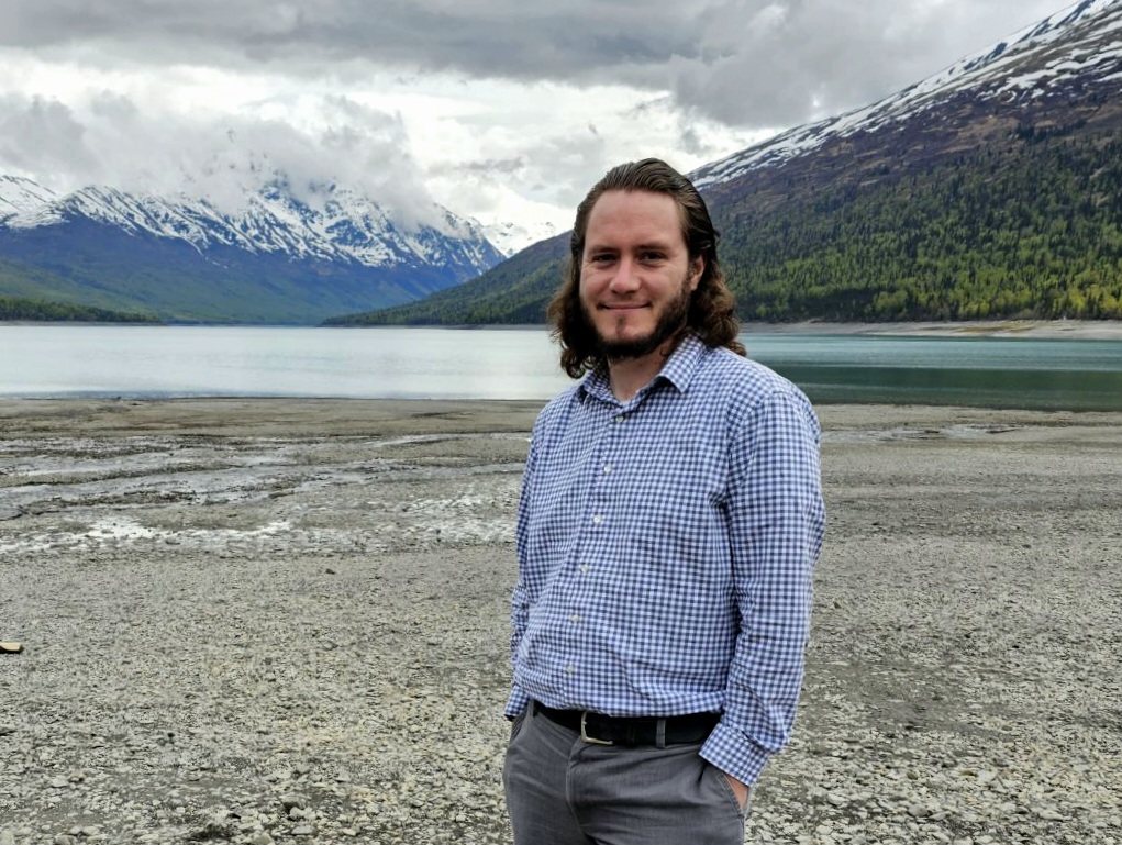 Dr. Cory Ortiz poses in front of scenic Juneau backdrop