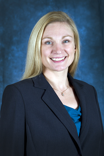 a woman with long blonde hair and suit