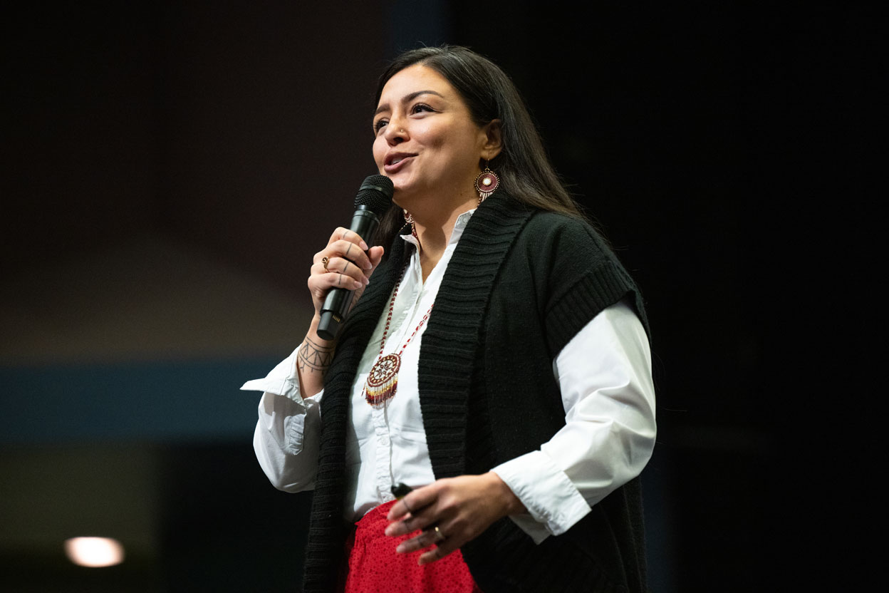 a woman speaks into a microphone